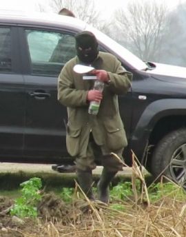 Maskierter Mann mit Flasche